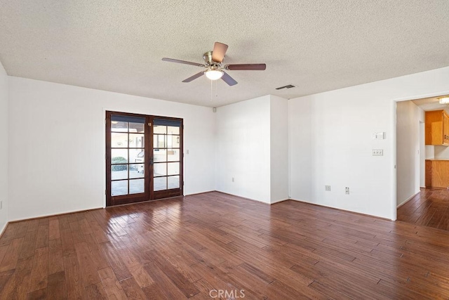 unfurnished room featuring ceiling fan, a textured ceiling, dark hardwood / wood-style floors, and french doors