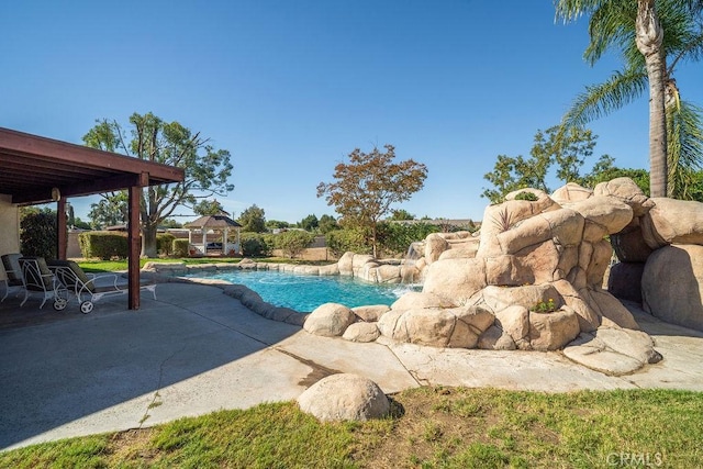 view of pool with a patio area and pool water feature