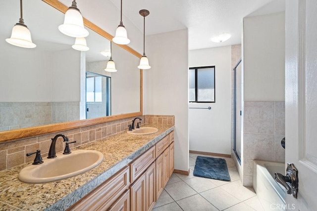 bathroom featuring tile patterned floors, walk in shower, vanity, and a healthy amount of sunlight