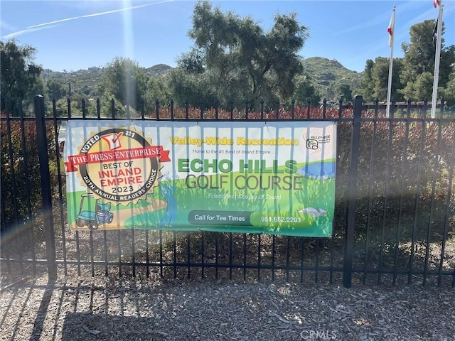 community sign with a mountain view