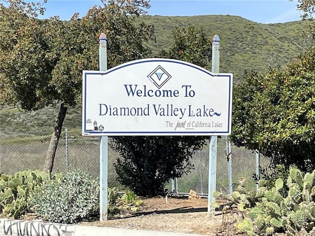 community / neighborhood sign with a mountain view