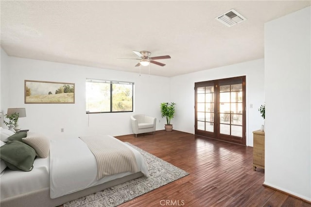 bedroom with dark hardwood / wood-style flooring, french doors, ceiling fan, and access to outside