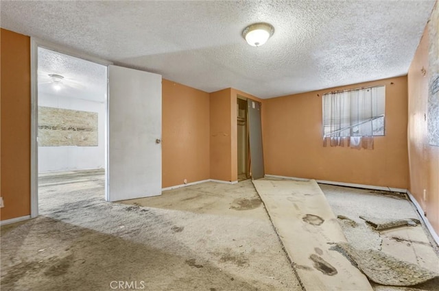 carpeted spare room with a textured ceiling