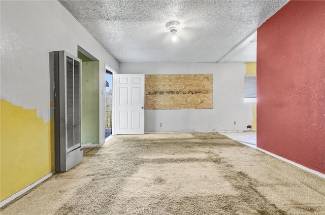 empty room with carpet and a textured ceiling