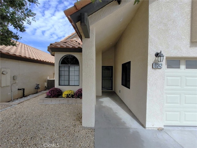 doorway to property featuring central AC unit