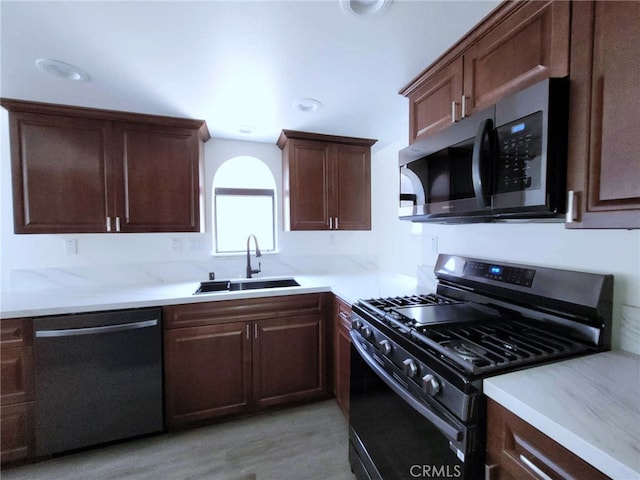 kitchen featuring light hardwood / wood-style flooring, appliances with stainless steel finishes, and sink