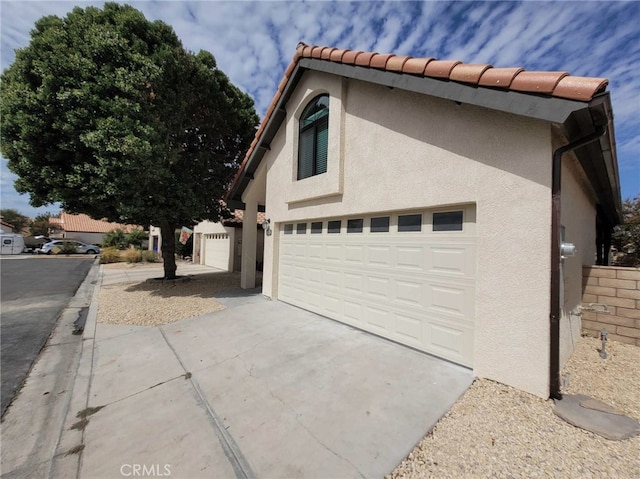 view of side of property with a garage