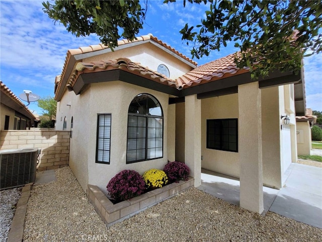 view of side of property featuring central air condition unit