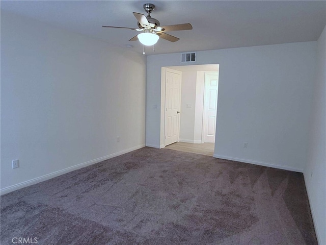 carpeted spare room with ceiling fan