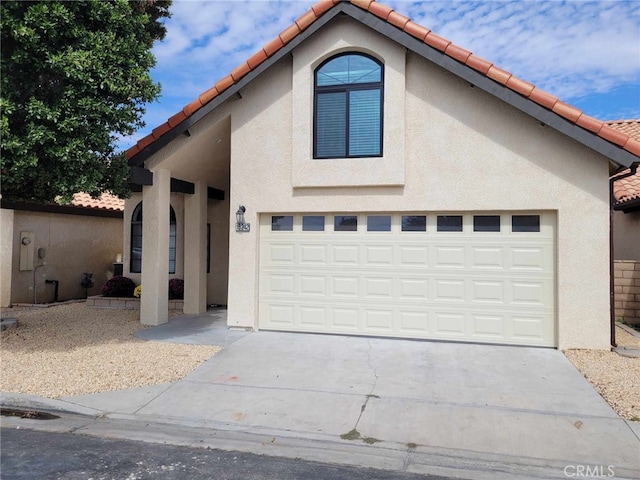 mediterranean / spanish-style home with a garage