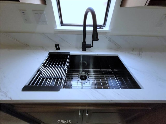 interior details featuring backsplash and sink