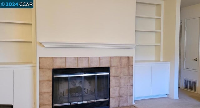 room details with carpet floors, a fireplace, and built in shelves