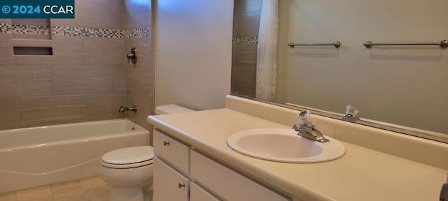 full bathroom featuring toilet, tiled shower / bath, vanity, and tile patterned floors