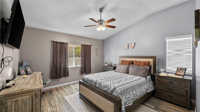 bedroom with light wood-type flooring, lofted ceiling, and ceiling fan