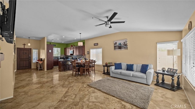 living room with ceiling fan and lofted ceiling