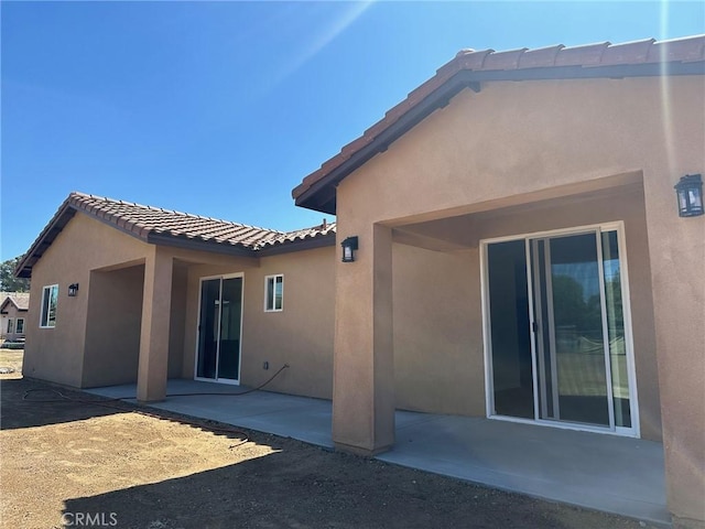 back of property with a patio