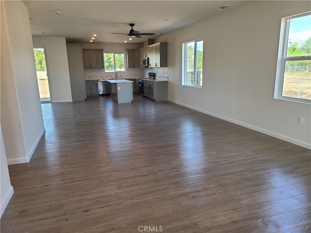 interior space featuring a wealth of natural light, dark hardwood / wood-style floors, and appliances with stainless steel finishes