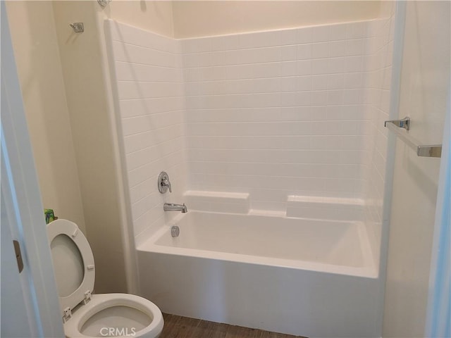 bathroom featuring toilet, shower / bathtub combination, and hardwood / wood-style flooring