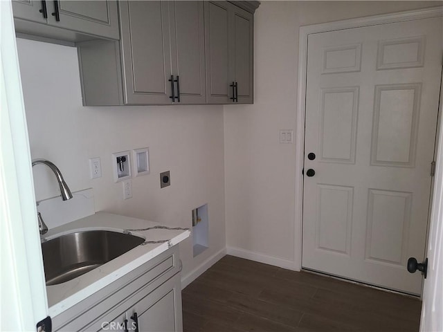 laundry area with sink, cabinets, hookup for an electric dryer, dark hardwood / wood-style floors, and hookup for a washing machine