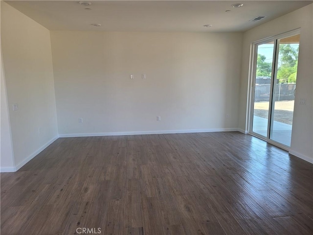 spare room with dark hardwood / wood-style flooring