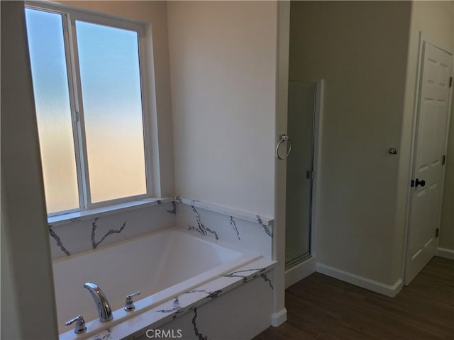 bathroom with plus walk in shower and wood-type flooring