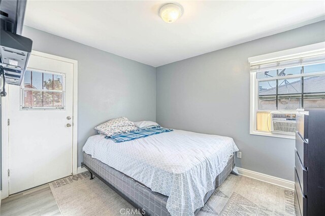 bedroom featuring cooling unit and light hardwood / wood-style floors