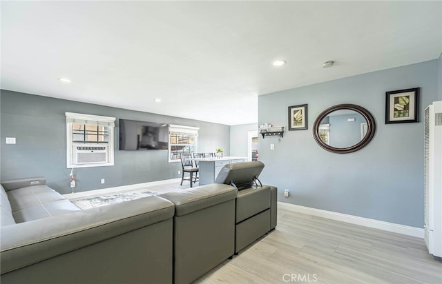 living room with light hardwood / wood-style flooring and cooling unit