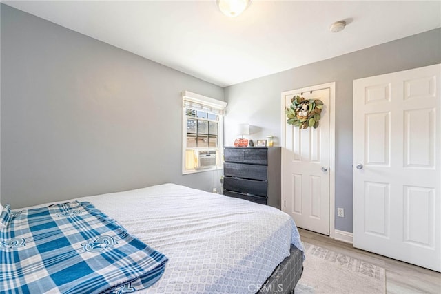 bedroom featuring cooling unit and light hardwood / wood-style floors