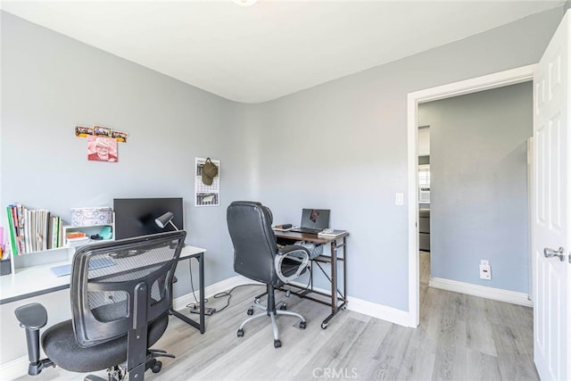 office with light hardwood / wood-style flooring