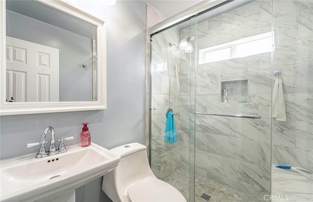 bathroom with toilet, sink, and an enclosed shower