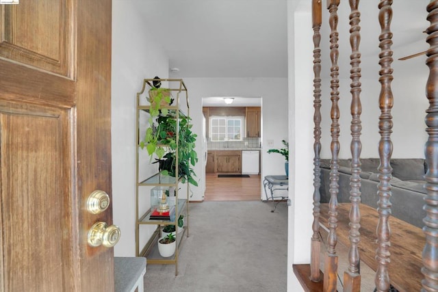 corridor featuring carpet flooring and vaulted ceiling