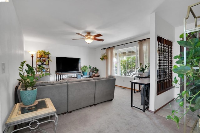 carpeted living room featuring ceiling fan