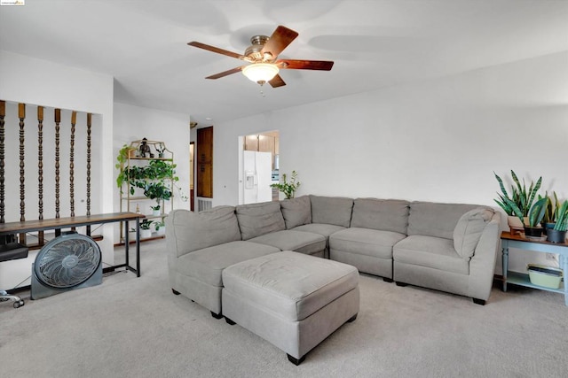 living room featuring light carpet and ceiling fan