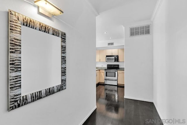 corridor featuring dark wood-type flooring and ornamental molding