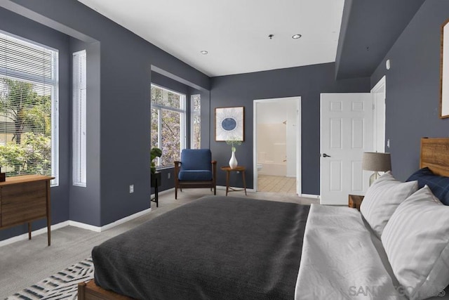 carpeted bedroom featuring connected bathroom