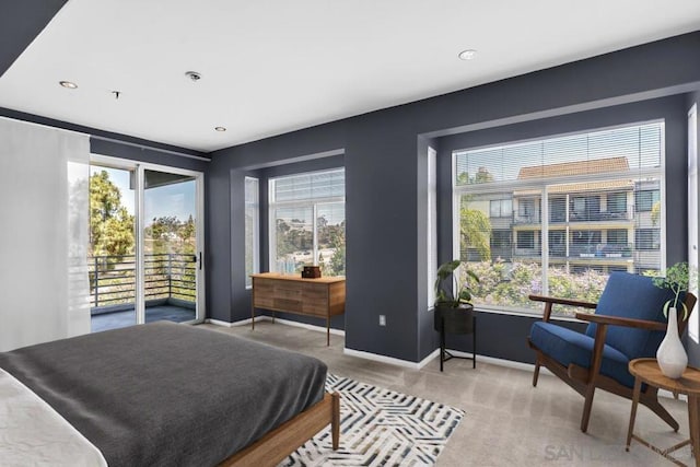 carpeted bedroom featuring multiple windows and access to outside