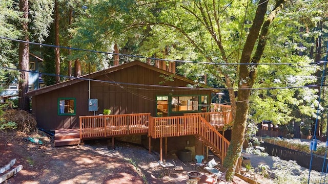 back of property with a wooden deck