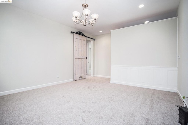 empty room with carpet floors and a notable chandelier