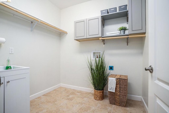 laundry area featuring sink, cabinets, and hookup for an electric dryer