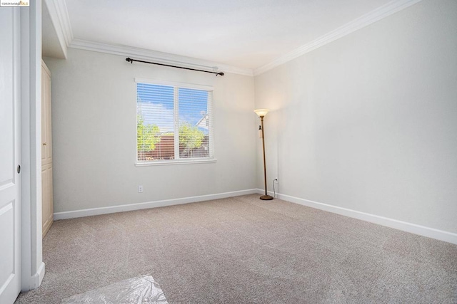 carpeted spare room with crown molding