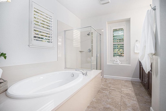 bathroom featuring separate shower and tub and tile patterned floors