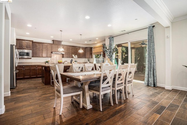 dining space with crown molding and dark hardwood / wood-style floors