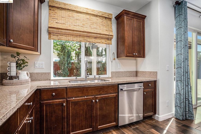 kitchen with dishwasher, sink, light stone countertops, dark brown cabinets, and dark hardwood / wood-style flooring