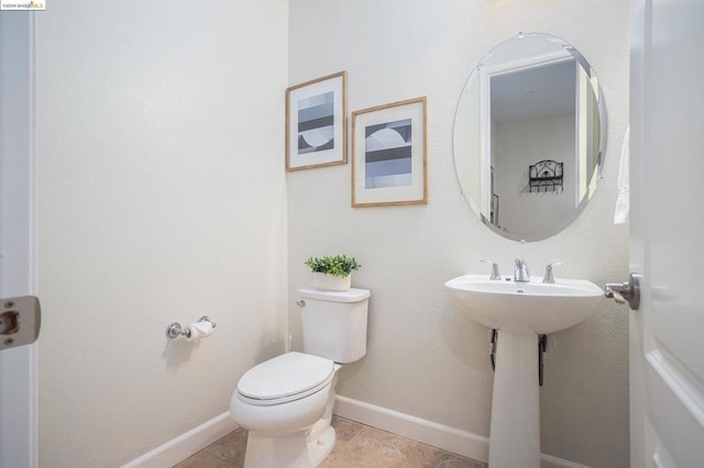 bathroom with tile patterned floors and toilet