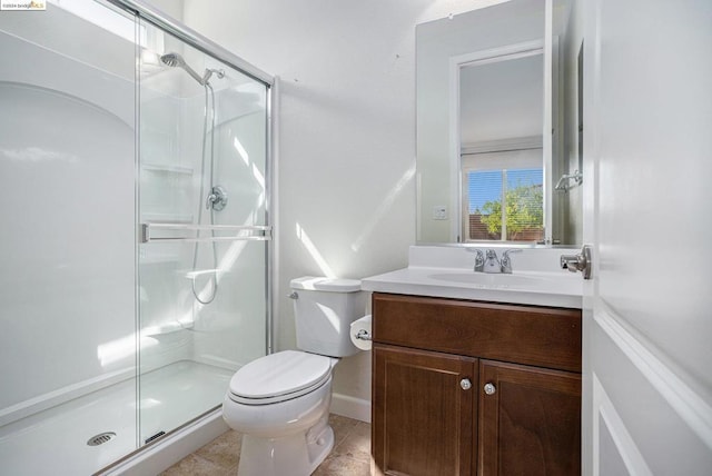 bathroom featuring tile patterned floors, vanity, an enclosed shower, and toilet