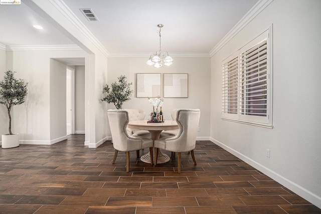 dining space featuring crown molding, dark hardwood / wood-style flooring, and a chandelier