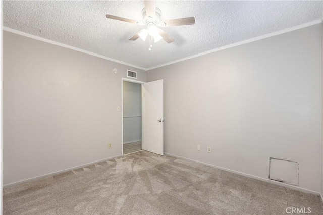 carpeted empty room with a textured ceiling, ceiling fan, and ornamental molding