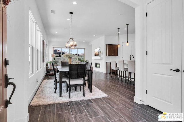 dining room with a notable chandelier and dark hardwood / wood-style floors