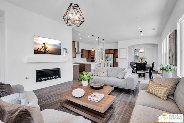 living room with an inviting chandelier and dark hardwood / wood-style flooring