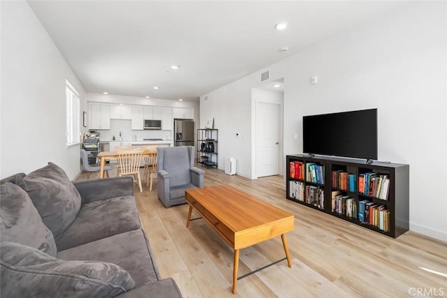 living room with light hardwood / wood-style flooring